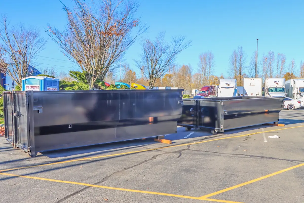Professional dumpster rental service with roll-off container on residential driveway in Rocky Mount